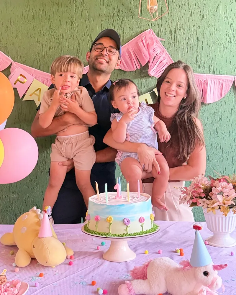 The family at their daughter's birthday, with the cake